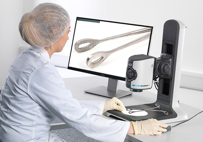 Woman conducting sterilization tool inspection with digital microscope