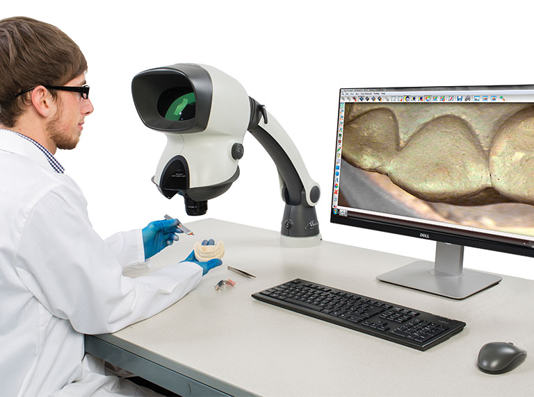 Dental technician using Mantis Compact ergonomic stereo microscope