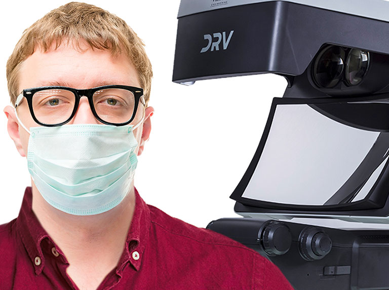 DRV-Z1-mask-and-goggles-786×572 Man in facemask and glasses PPE next to DRV 3D viewer system