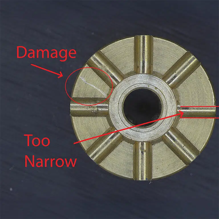Image of a machined component with signs of damage and compliance issues