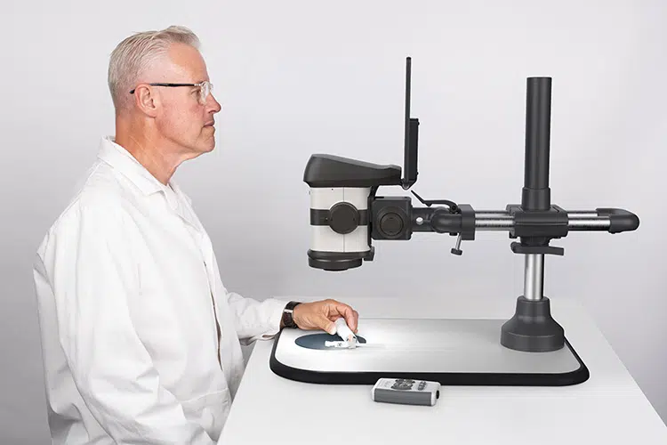 Man viewing a medical device with the ProteQ VISO digital stereo microscope